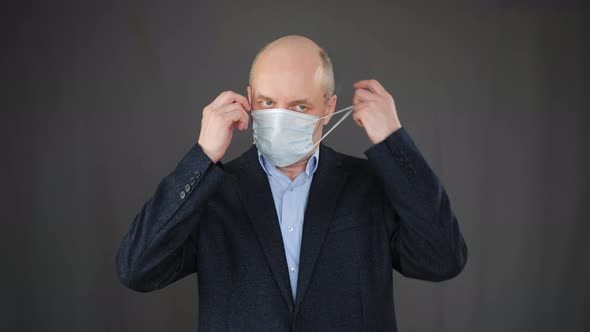 Portrait Businessman Taking Off Facial Mask After Epidemic Covid-19. Healthy Man Removing Medical