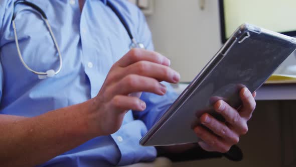 Doctor working and using digital tablet in a retirement home