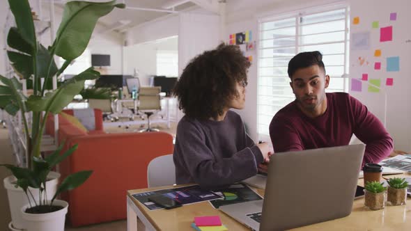 Two colleagues working in creative office