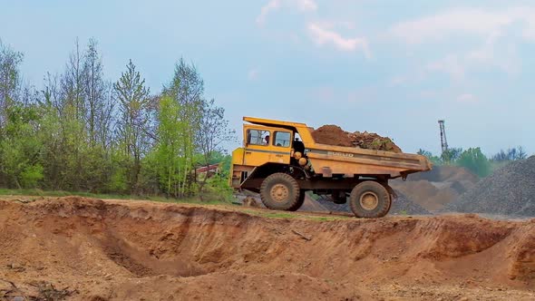 Large mining truck. Large quarry truck in the background of hills