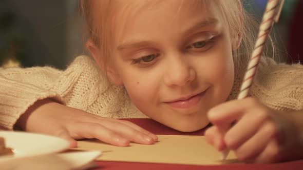 Girl Writing Letter to Santa Claus, Dreaming of Christmas Miracle, Closeup