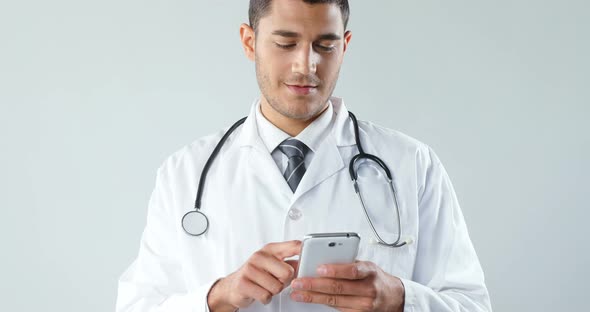 Smiling doctor using a smart phone 4K 4k