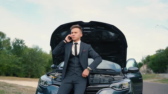 Young Man Standing Speak on Phone Calling Car Assistance Services