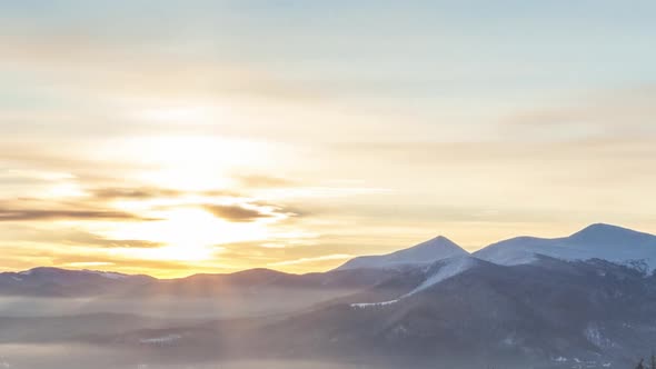 Foggy Morning in the Winter Mountains Forest on the Background of Dramatic Cloudy Sky