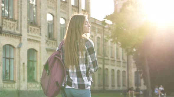 Student Girl Walking in The Park to The College Building