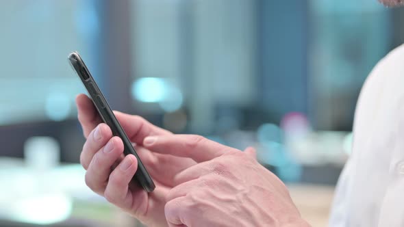 Close up of Middle Aged Arab Man using Smartphone