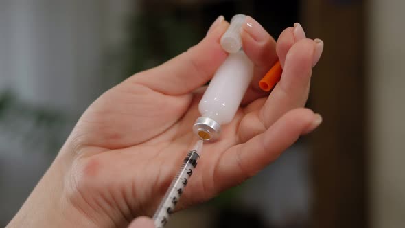 A Diabetic Woman is Preparing to Take an Injection of Extended Insulin