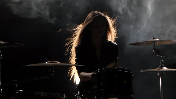 Girl Is Kicks From Playing Drums, Playing Energetic Music, Black Smoke Background, Silhouette