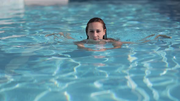 Young Sexy Woman Having Fun in the Swimming Pool