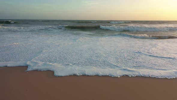 waves and sea foam on the beach