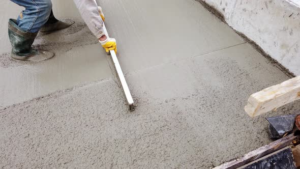 Worker Flattens Cement Mortar