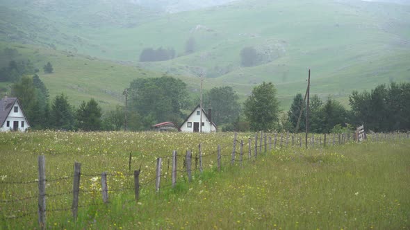 Houses at the Foot of the Mountains in the Green Valley