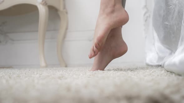Close Up Shot of the Woman's First Morning Step From the Bed To the Carpet Floor with Bared Feet in