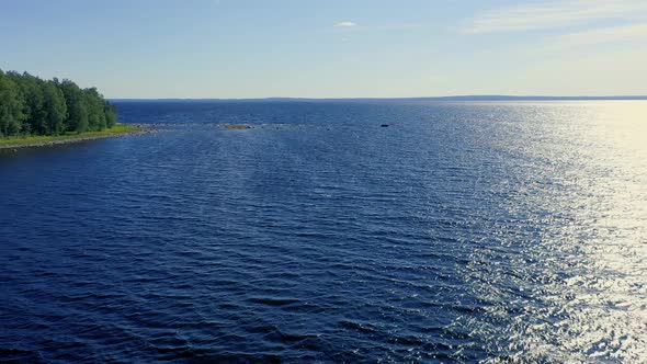 Flight over the ocean. Aerial ocean coastline view. Top fly over the sea.