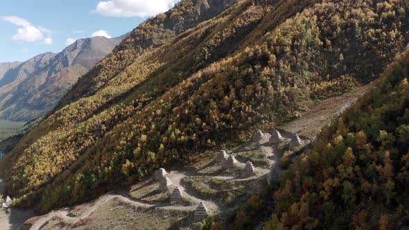 Pyramids Against Snow Avalanche on Mountainside Covered with Autumn Woodland. Avalanche Dam on