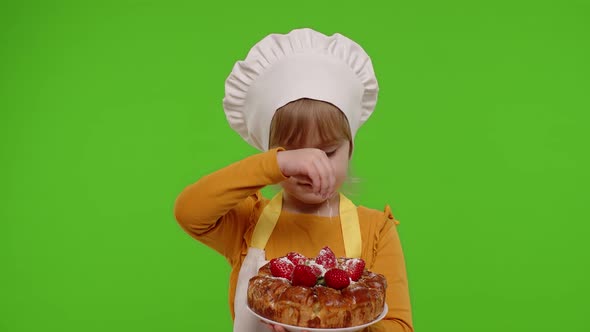 Child Girl Kid Dressed As Cook Chef Sprinkle Strawberry Pie with Icing Sugar Chroma Key Background