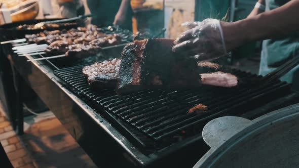 Meat Is Grilled at Street Food Festival. Large Pieces of Pork Roasted on the BBQ