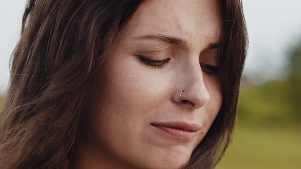 Young Beautiful Woman Squinting with Her Eyes Closed