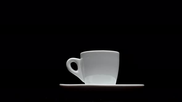 A Cup of Hot Coffee on a Black Background