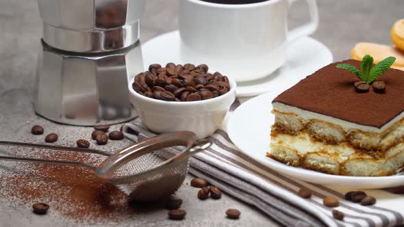 Portion of Traditional Italian Tiramisu dessert and savoiardi cookies on grey concrete background