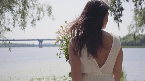 Portrait Young Girl with Long Brunette Hair Wearing a Long White Summer Fashion Dress