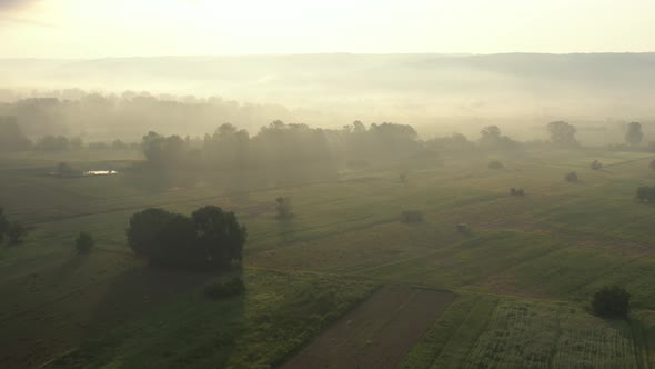 Agricultural land from above with misty mood light 4K drone footage