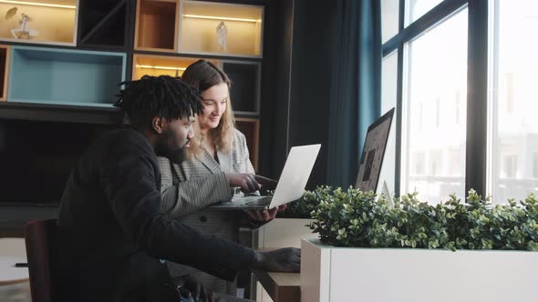 African American Business Man and His Assistant Light Girl Discussing Tasks for the Day at Office