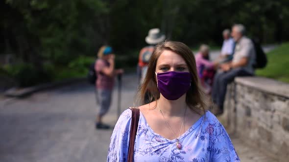 Female with Face Mask and Sling Bag Walking