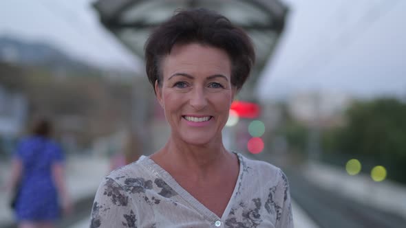 Mature Beautiful Tourist Woman Smiling At The Train Station