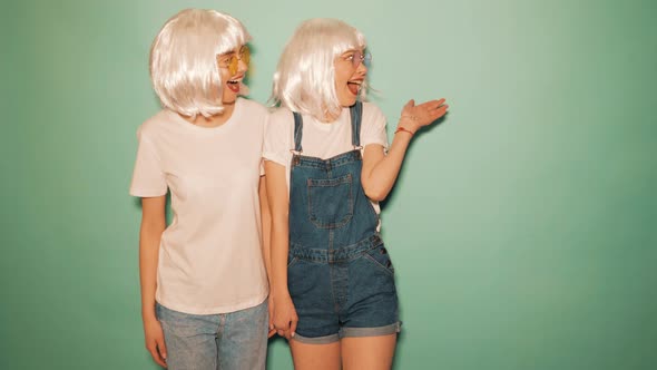 Two carefree young girls going crazy in studio