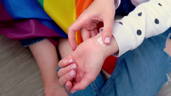 Closeup of Young Caucasian Millennial Hippie Woman Making Rainbow Flag in Heart Shape Painted in