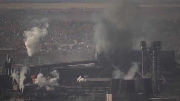 large amount of smoke and soot is emitted from the factory pipes of the metallurgical plant