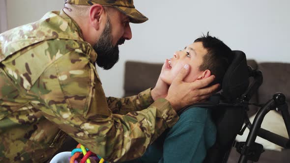 Veteran soldier greeting his son with disability reunited after US army service - Family concept