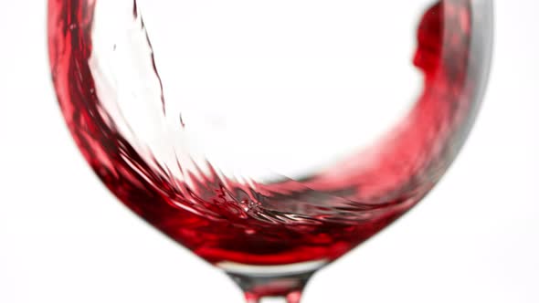 Super Slow Motion Detail Shot of Pouring Red Wine Isolated on White Background at 1000Fps