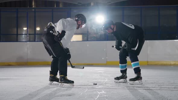 Slow Motion Confrontation of Two Hockey Players Rival Teams Start the Game Hockey Players in