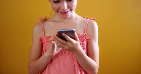 Schoolgirl using mobile phone in classroom