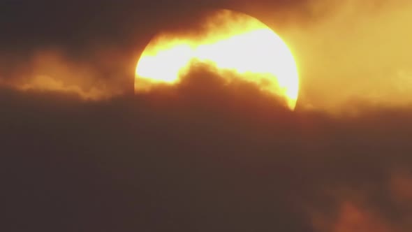 Timelapse a Large Sun Sets in Orange Clouds That Turn Blue