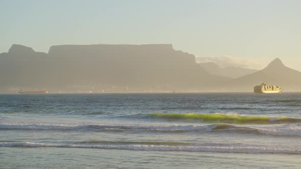 Beautiful Clear Day Looking To Table Mountain and Mother City with Ocean Waves Crashing Over Rocky