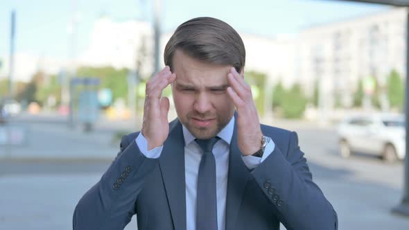 Portrait of Businessman having Headache Outdoor