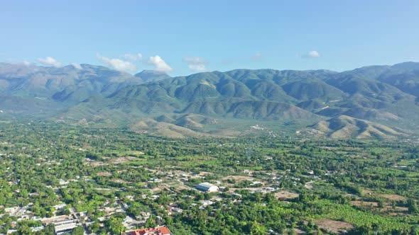 Neiba or Neyba city and mountain in background. Aerial backward