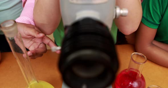 Classmates looking through a microscope