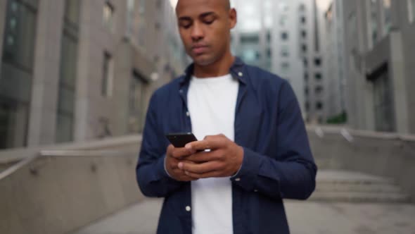 Ethnic Male Texting Message on Smartphone