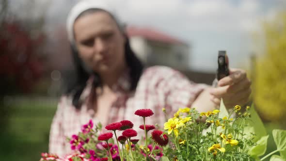 Girl Sprays Flowers in the Garden