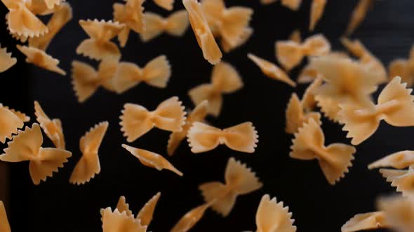 Delicious farfalle pasta on a black background. 