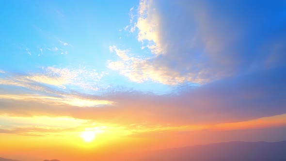 4K : Colorful of clouds above mountain during sunset.