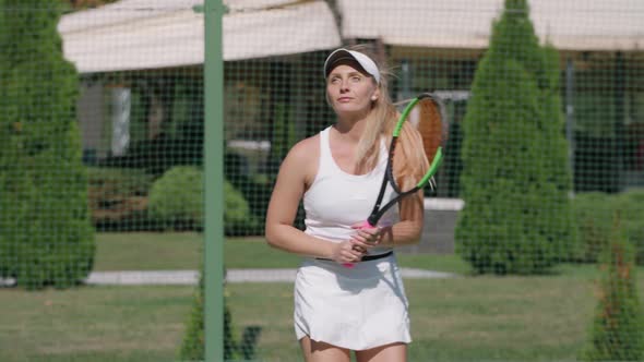 Woman Professional Tennis Player Hits the Ball with a Racket Practice Game on the Tennis Court Hits