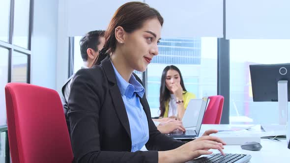 Asian employee officer attractive positive smile woman working on desktop