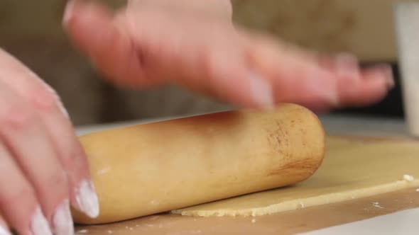 The Woman Rolls Out The Biscuit Dough. Cooking Marshmallow Sandwiches.