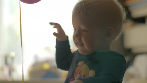 One year old baby girl with balloons