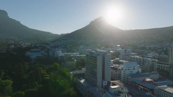 Town Development and Lions Head Mountain Against Bright Sun